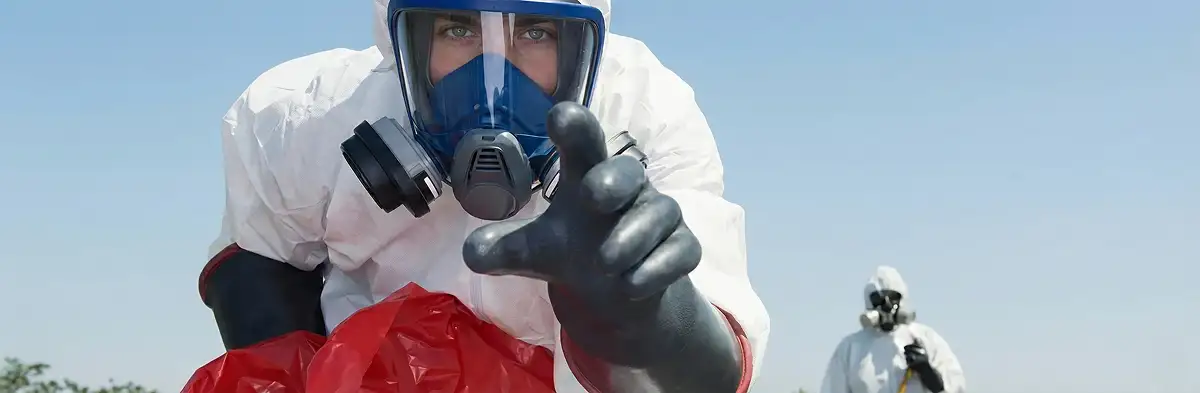 sewage clean up technician wearing protective gear handling biohazard materials in Naperville, IL