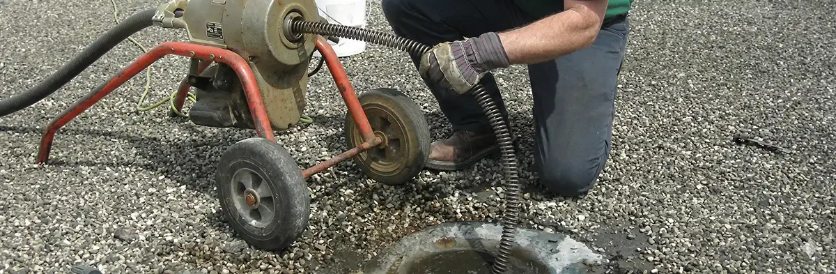 sewer rodding technician actively removing blockages from a sewer line in Naperville, IL