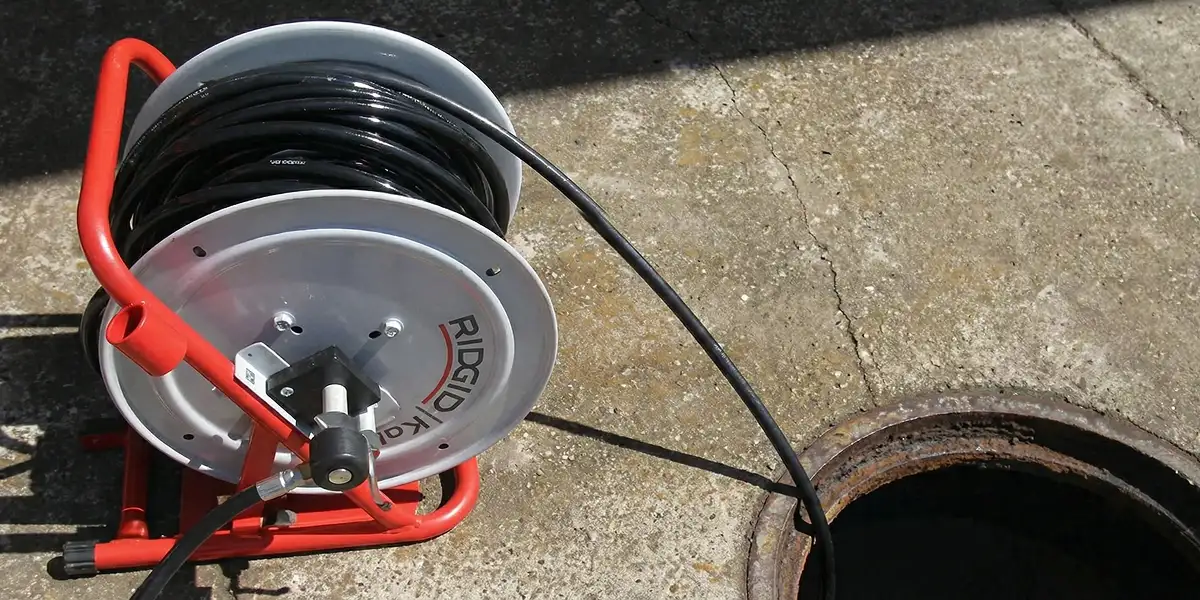 sewer rodding equipment prepared to clear clogged sewer lines in Naperville, IL